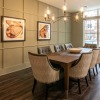 a room with a large table and chandelier 