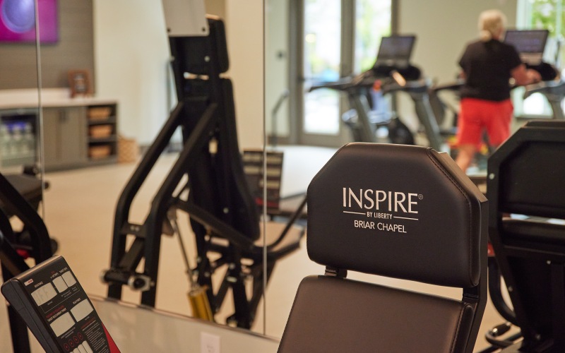 a fitness center with someone on the treadmill