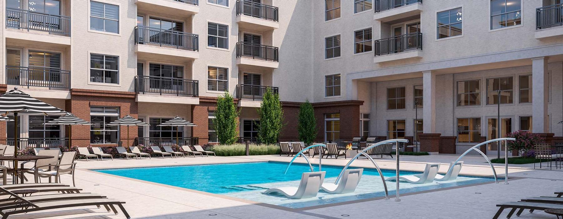 a large building with a pool in front of it