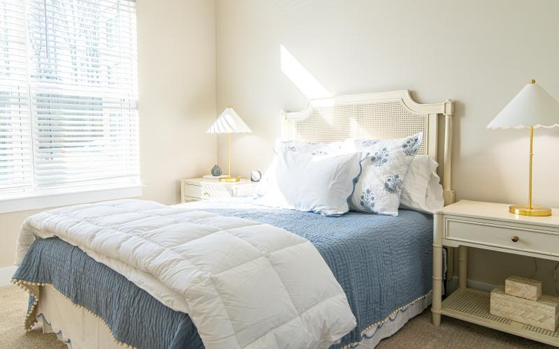 a bed with a blue comforter