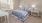 a bedroom with a bed and a table