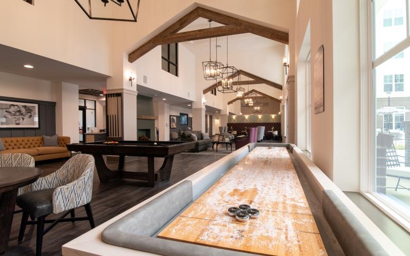 a large room with a pool table and chairs